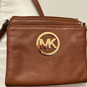 Michael Kors brown crossbody with adjustable strap and gold logo